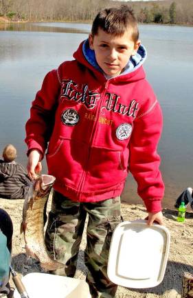 Nine- year-old Fernando Coba-Gomez shows off one of the five trout he caught in less than 40 minutes.