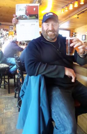 Paul DePaoli, &quot;Mr. June,&quot; is a retired executive happy spending his days helping his father-in-law at Clearfield Farms raising and selling eggs, locally raised beef, port and chicken, in addition to animal feed. He&#x2019;s an avid outdoorsman and a body builder too. He enjoyed a cold one at KC Pepper Bar &amp; Grille. (Photo by Frances Ruth Harris)