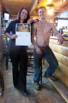 Kate Rossini holds the calendar started off by &quot;Mr. March,&quot; Shane Richard, pictured left (Photo by Frances Ruth Harris)