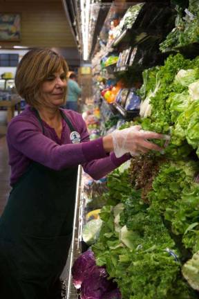 Photo by Katiejo Kardel Earlier this week, Diana Bortnichak of Milford helped get the produce department ready for Keyfood's grand opening celebration.