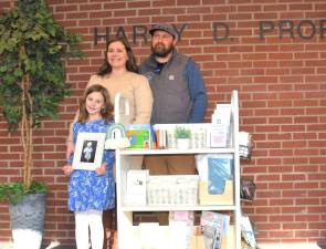 Ella, Katie and Cody Yedinak with a picture of Hudson John.