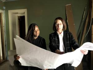 Family Promise in Pike County Case Manager Erika Ambrose (l), and Executive Director Enid Logan, examine one of several historic pieces that will be preserved in the renovation of a building recently purchased to help unhoused families in the county.