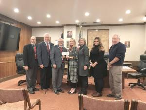 Left to right: Commissioner Tony Waldron, Commissioner Ronald R. Schmalzle and Commissioner Matthew Osterberg, handing a $2 million check to Greater Pike Community Foundation Executive Director Jenni Hamill, standing with Gail Shuttleworth, Jessica Zufall, and Robert Martin.