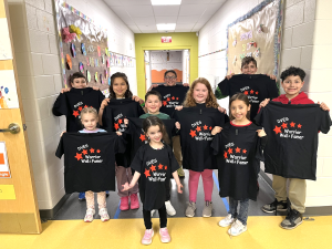March students of the month pose proudly with their Warriors’ shirts.