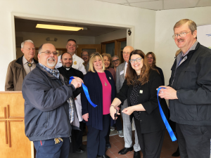 Joined by employees and guests, CEO Shannon Kelly cut the ceremonial ribbon at Catholic Charities of Orange, Sullivan &amp; Ulster’s new office location in Port Jervis, NY.