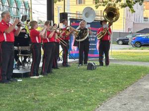 The Broome Street Marching band, with Shary Kranch on the white sousaphone performs at Veterans Park.