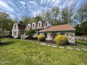 Luxury stone manor house has a private pond and pool