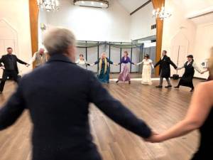 Attendees participate in a Regency-era dance at the Hanna Q Dance Company ball.
