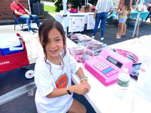 Naryn Timpone, 7, sold pretzels covered in chocolate or strawberry icing during the second annual Acton Children’s Business Fair on June 25, 2023 in Milford.