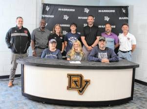L-R Front: Dawn Sukovich, Scarlet Sukovich, and Mike Sukovich. L-R Back: Assistant soccer coach Jeff Luhrs, coach Abe, coach Jenn, Nolan (brother), assistant soccer coach Brian Sweeney, DVHS Principal Lou DeLauro, and head soccer coach Kevin Quinn.