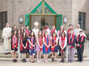 Bishop Bambera is pictured with Confirmation candidates just before the celebration of the Eucharistic Liturgy and Confirmation ceremony in May. Looking on are Father Joseph Manarchuck, Pastor, and Deacon Thomas Spataro (Photo by Jay A. Asper)