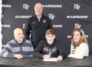 Delaware Valley High School senior Tyler Cottone is flanked by his parents, Ryan Cottone on his left and his mother Kristine Cottone on his right. Delaware Valley head soccer coach Aaron Stark stands behind his team’s captain. Photo provided by Leslie Lordi/Delaware Valley High School.