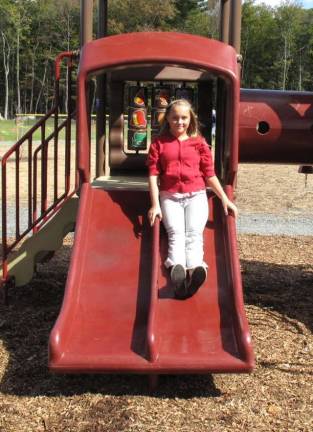Photo by Jerry Goldberg. See more at pikecountycourier.com Samantha Collins, 12, is one of the first children to use the new playground slide.