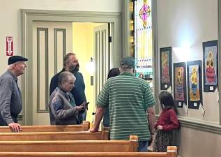 Guests enjoy artwork at a recent Spring Arts Festival.