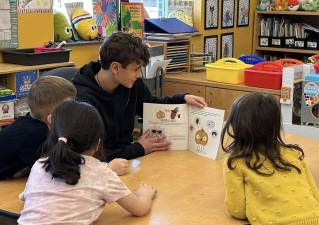 Delaware Valley High School freshman Blake Luhrs reads to the elementary students as part of a National Read Across America Day program. Photos provided by Leslie Lordi/Delaware Valley High School.