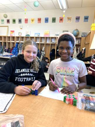 DVES students work with unit cubes to learn about volume.