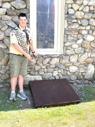 Evan Deckinger of Milford Scout Troop 1071 shows off one of nine window well covers he built for Good Shepherd Episcopal Church.