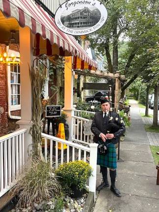 Jeff McQuaid playing the bagpipes to welcome people to the dinner at the Dimmick Inn on Sept. 17, 2025.