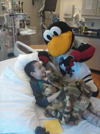 A visitor cheers up Daniel DePolito during a hospital visit (Photo provided)