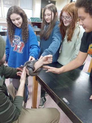 Derek Scott from the Pocono Environmental Education Center brought a black rat snake to a recent meeting of the Dingman-Delaware Middle School Environmental and Nature Club.