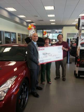 Photo by Alexis Tarrazi From left: Michael Spano, Sales and Marketing Analyst for the Northeast Region for Nissan, local winner Mary Morgan with her oversized $10,000 check and Jerry Goldstein, owner of Nissan of Middletown, Warwick and Port Jervis.