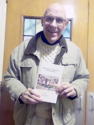 Bill Kiger brought a copy of O'Neil's published poems for each member of the council. (Photo by Frances Ruth Harris)