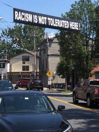 Last summer saw a spate of dueling signs around Warwick, including this banner across West Street. After receiving calls about a pro-police banner, the village considered limiting banners to local event promotion to avoid a banner war. (Photo: Daniel Mack)