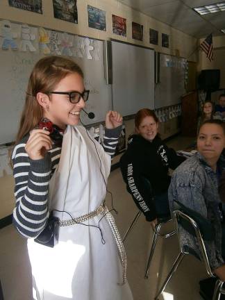 Anna Crapanzano checks her mic. To the right is Kate Garrera, and Samantha Orneck is to the left. Hailee Teta is pictured in back (Photo provided)