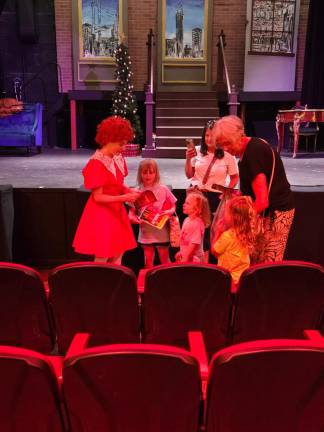 Four little girls all wearing Annie T-shirts and holding lockets (Annie had a locket in the show). They said, “I love you, Annie” and asked for her autograph.