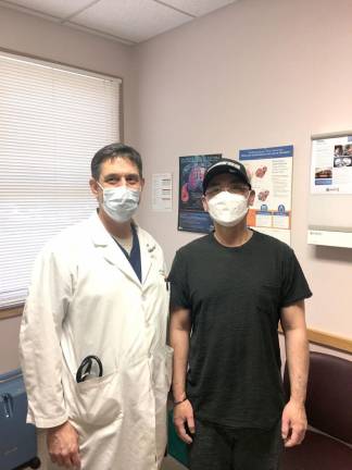 Dr. McVeigh with COVID-19 survivor Kwok Chung Lau.