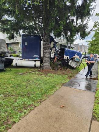 A damaged 2016 Freightliner comes to a rest after wreaking havoc and killing one in Milford July 29.