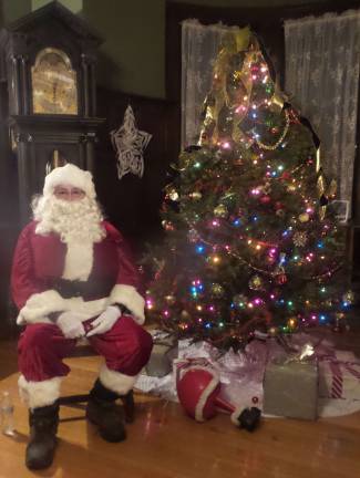 Santa's ready for the party to begin. (Dennis Kelly was Santa Claus in costume for the first time in his life!) (Photo by Frances Ruth Harris)