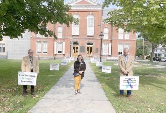 Pictured installing Suicide Prevention Month signs on the lawn of the Pike County Courthouse are, from left: Pike County Commissioner Chair Matthew Osterberg; Larissa Kimmel, System of Care Coordinator for Carbon, Monroe and Pike Counties; and Pike County Commissioner Vice Chair Ronald Schmalzle. (Photo provided)