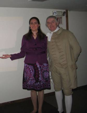 Cora C. poses with Paul B. portraying President George Washington. Cora delivered the presentation on presidential horses.