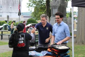 NY State Sen. James Skoufis and a staff member hand out backpacks to students in Port Jervis last week.