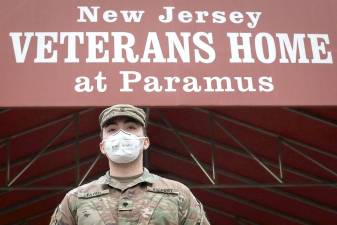 New Jersey Army National Guard Combat Medic Spc. Gabriel S. Fayed stands ready to direct arriving Citizen-soldiers at the New Jersey Veterans Home at Paramus on April 9: approximately 75 combat medics will be providing medical support for the residents at both the Paramus Home and the New Jersey Veterans Memorial Home at Menlo Park. The Homes, which are run by the New Jersey Department of Military and Veterans Affairs, have more than 540 residents who have served in every war since World War II. The New Jersey National Guard is supporting state and local officials with the COVID-19 relief effort.