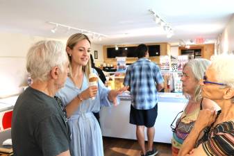 Paige Cognetti enjoys a cone while speaking with community members in Milford.