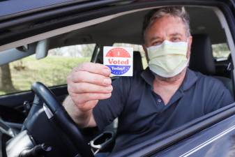 Primary voters urged, but not required, to wear masks