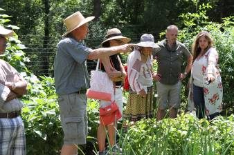 Frank Hennion showing ticketholders around his garden in Franklin, N.J., during Dirt magazine's garden tour on July 29. His garden was judged best kitchen garden and he was named most hospitable host. Photo by Clinton Hill.