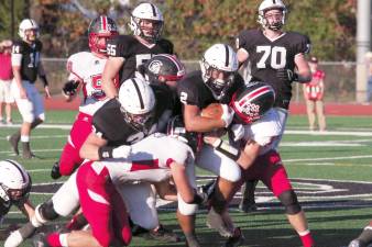 Delaware Valley ball carrier Josh Balcarcel battles North Pocono defenders as he forces his way forward. Balcarcel rushed for 149 yards and scored 3 touchdowns. He was also crowned Homecoming King at halftime.