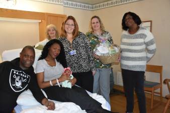 From left: Favato Koradis, grandfather; mom Jana holding baby Jadinna; Pat Konzman, CNM; MacDowell; Nancy Thompson, RN; and Fiandra Koradis. (Photo provided)