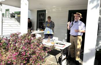 Left to right Carol McManus and Brian Carso (co-chairs of MRAW ) addressing guests on porch of John Wallace house in Milford