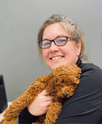 Veterinary Center of Hardyston office manager Melissa Maher with patient Micco, an eight-month-old mini-doodle. (Photo provided)