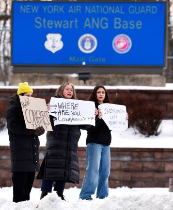 Protesters in front of Stewart Air National Guard Base before the arrival of captured Venezuelan President Nicolas Maduro, in Newburgh, N.Y. (AP Photo/Noah K. Murray)