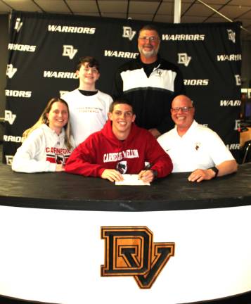 Mike Iuzzolino announces his commitment to play football at Carnegie Mellon. Front row (L-R): Jeanine Iuzzolino, Mike Iuzzolino, and Michael Iuzzolino. Back row (L-R): Brother Matteo and head coach Keith Olsommer.
