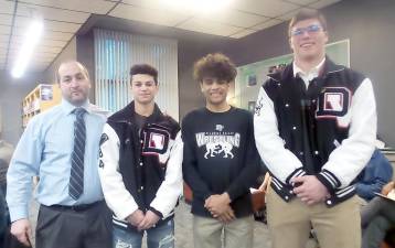 Outstanding wrestlers were introduced with their coach, Lou DeLauro: Landon Machado, Zac Jacaruso, and Aiden Black. (Photo by Frances Ruth Harris)