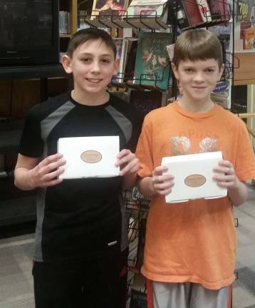 Blind Date winners Nikolay Dana (left) and Seth Williams show off their chocolate-covered strawberry prizes (Photo provided)