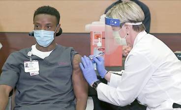 Ja’Ray Gamble was the first in Pennsylvania to receive Pfizer’s COVID-19 vaccine, which was administered Monday by Tami Minnier, chief quality officer at UPMC Children’s Hospital of Pittsburgh. Gamble is a transporter at the hospital, so “he’s right in the thick of things,” Minner said. (upmc.com)