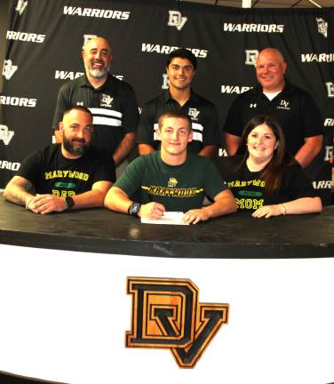 Chris Devaney signs his letter of intent to play lacrosse at Marywood University. Front row (L-R): CJ Devaney, Chris Devaney, and Megan Smith. Back row (L-R): Head coach Dan Gonzalez, assistant coach Josh Balcarcel, and former head coach Jeff Krasulski.