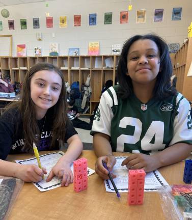 DVES students work with unit cubes to learn about volume.